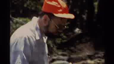 Lake Tahoe California USA (1978): Man Wearing Red Hat Fixing Fishing Line On A