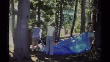 LAKE TAHOE CALIFORNIA USA-1978: Three Women Setting Up A Blue Tarp In Forest Campsite