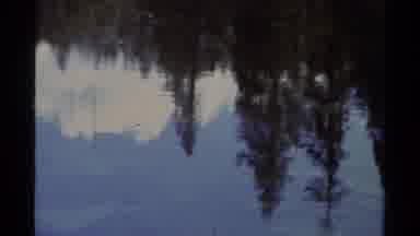 Lake Tahoe California USA (1978): Reflection In Lake Pans To Man And Zooms In