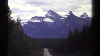 British Columbia Canada (1979): Road Through Trees Leading To A High Mountain In