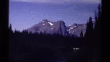 British Columbia Canada (1979): Blue Mountains Stand Tall Behind Several Rows Of