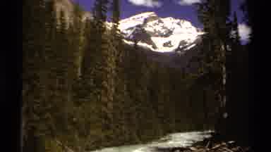British Columbia Canada (1979): Snow Covered Mountains In The Distance With Trees
