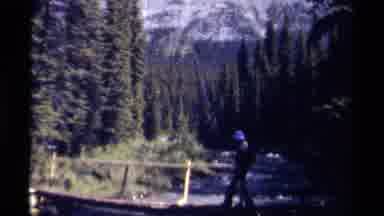 British Columbia Canada (1979): Man Walks Across Wooden Bridge In Forest Clearing