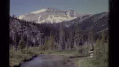 British Columbia Canada (1979): A Still Lake With A Person Walking By It And A