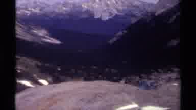 British Columbia Canada (1979): Camera Pans To Show Mountain Range One Person Sits