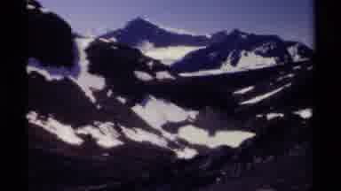 British Columbia Canada (1979): Snowy Mountains With People Hiking Along Body Of