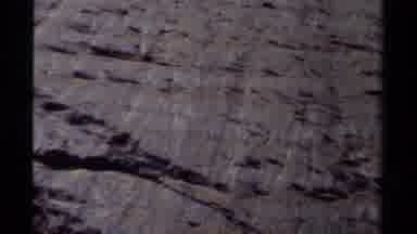 British Columbia Canada (1979): Person Walking Past Sheer Rock Wall On A Bright