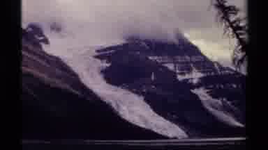 BRITISH COLUMBIA CANADA-1979: Large Gray Foggy Mountains Covered In Snow Looks