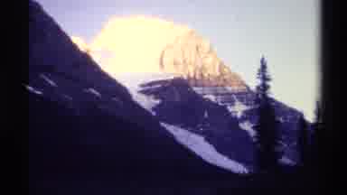 British Columbia Canada (1979): Mountain Range With Trees Changes Lighting As The
