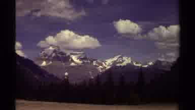 British Columbia Canada (1979): Far Away Snow Covered Mountains On A Partly Cloudy