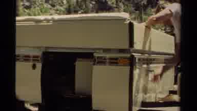 Mendocino California USA (1980): Person Using A Hand Crank To Close Up A Box