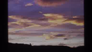 Alaska USA (1977): The Dawn Sky Filled With Light Clouds And Dark Land Under It
