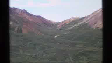 Alaska USA (1977): A Mountain Pass And A Group Of Hikers Walking Uphill Across A