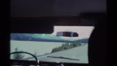 ALASKA USA-1977: Person Drives Past Seaside With Mountain Views
