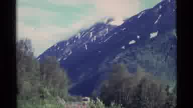 ALASKA USA-1977: Majestic Snow-Capped Mountains Rise Above Forested Valleys