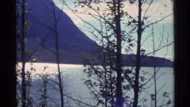 Alaska USA (1977): A Blue Ocean View With Mountains And Trees In The Background
