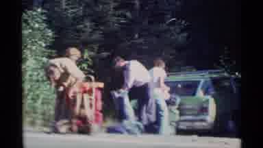 Alaska USA (1977): A Group Of Backpackers Loading Up Their Packs In A Parking Lot