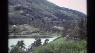 Alaska USA (1977): Mountain Side Lake With Zoom In With Campers Close Up With Man