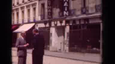 Paris France (1939): Men Conversing On An Urban Street With Women Walking Along
