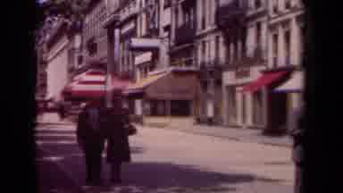 Paris France (1939): A Couple Slowly Walk Down A Crowded Street In The City