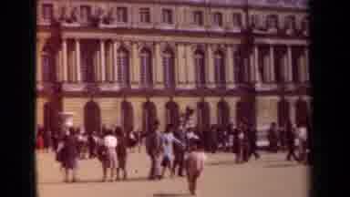 PARIS FRANCE-1939: People Walk By A Tall Historic Looking Building And Gather At