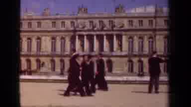 Paris France (1939): People Walking By Stone Building And Sculpture On A Bright