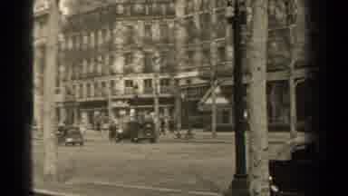Paris France (1947): Old Cars Drive Through The City Quickly While Pedestrians