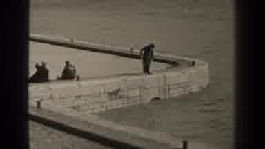Paris France (1947): Man In A Long Coat Stand On A Stone Wall And Fishes While