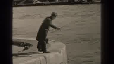 Paris France (1947): Men In Long Coats Fish While Standing On A Tall Rock Wall
