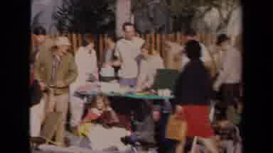 Los Angeles California USA (1967): People Camping Out On Sidewalk Watching Cars Go