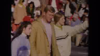 Los Angeles California USA (1967): Three People Walking In Front Of A Crowd On