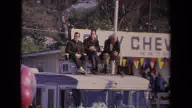 Los Angeles California USA (1967): Man In White Suit With Red Arm Band Walking In