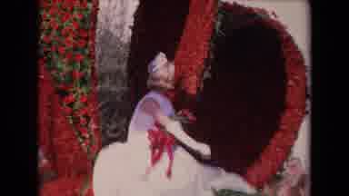 Los Angeles California USA (1967): Woman Wearing White Dress Under A Red Heart