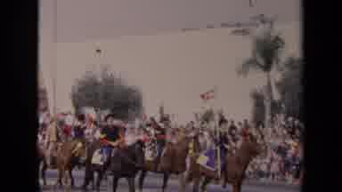 LOS ANGELES CALIFORNIA USA-1967: Horseback Riders March in Parade with Crowds