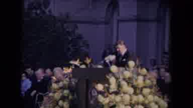 Ronald Regan Inaguration Sacramento Cal (1967): A Person Speaking At A Memorial