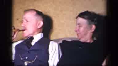 Sebring Ohio USA (1942): Man And Woman Sit Together Closely While The Man Smokes A