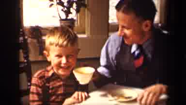 Sebring Ohio USA (1942): Well Dressed Man Making A Young Boy Laugh By Offering Him