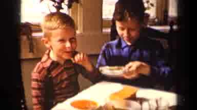 Sebring Ohio USA (1942): Two Young Boys Are Sharing A Snack Together At A Table
