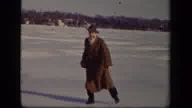 Sebring Ohio USA (1942): Man In Brown Trench Coat Walks Clumsily Across Frozen