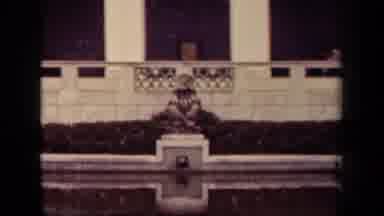 Washington DC USA (1943): Person Dressed Uniquely Sits Quietly At Edge Of Pool Of