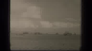 LEYTE GULF PHILIPPINES-1944: A Sailor On Deck With Naval Fleet In The Distance