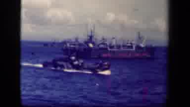 LEYTE GULF PHILIPPINES-1944: Vehicle With Treads Suspended Over Ocean By Crane