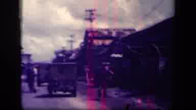 Leyte Gulf Philippines (1944): Cars Go By In Dirt Road By Vegetation And Palms