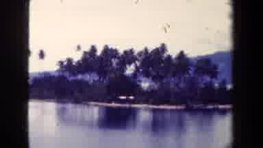 PAPUA NEW GUINEA-1944: A Slow Moving View Of A Lake Surrounding A Small Landmass