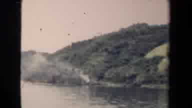 PAPUA NEW GUINEA-1944: River Flowing Along Forested Landmass