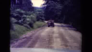 Papua New Guinea (1944): Following A Jeep Driving Down A Dirt Road Next To Some