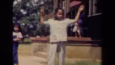 Kauai Hawaii USA (1944): Young Girl Wearing White Outfit Dancing With Her Hands In