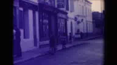 France (1945): People Walk Down A Street And Stop To Admire A Building In Front Of