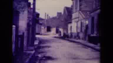 France (1945): Vintage Film Clip Of An Empty City Street With Someone Carrying