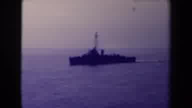 France (1945): Two Large Naval Ship Sails Through The Water In The Middle Of The